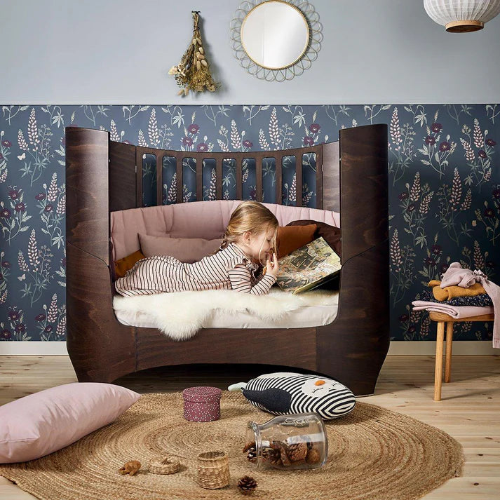 child reading sitting in kids bed