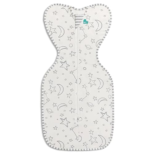 A cream-colored baby swaddle with stars and moons pattern, featuring a zip-up front.